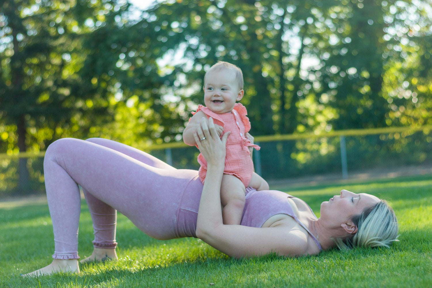 mom exercising holding baby