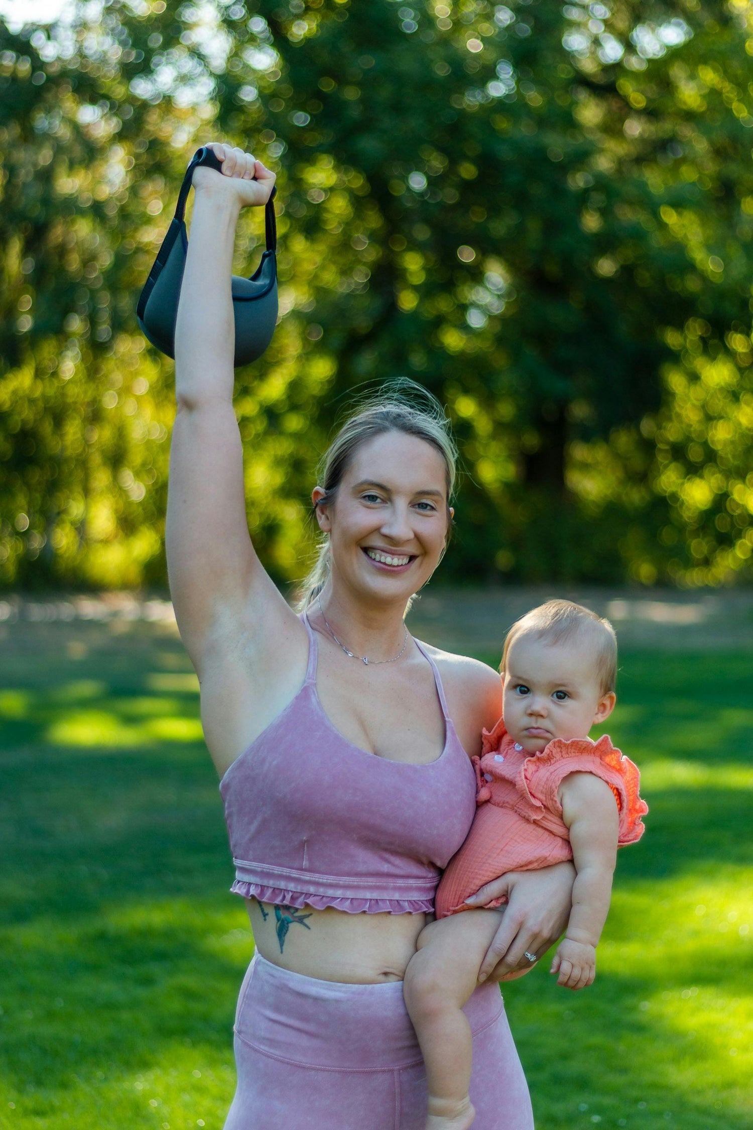 mom lifting weights with baby